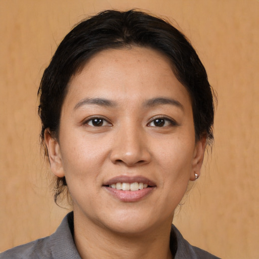 Joyful white young-adult female with medium  brown hair and brown eyes