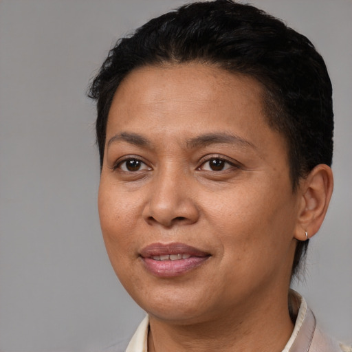 Joyful latino adult female with short  brown hair and brown eyes