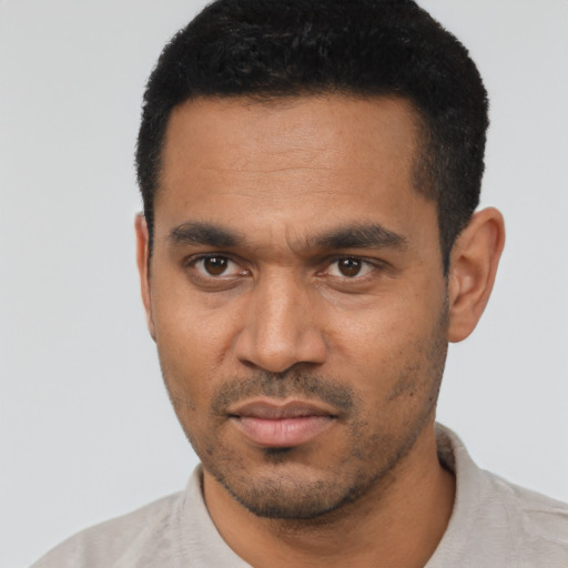 Neutral latino young-adult male with short  black hair and brown eyes