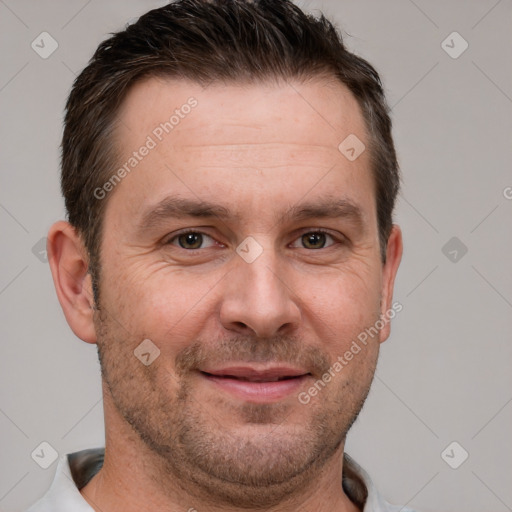 Joyful white adult male with short  brown hair and grey eyes