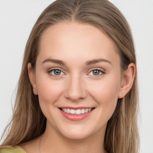 Joyful white young-adult female with long  brown hair and grey eyes