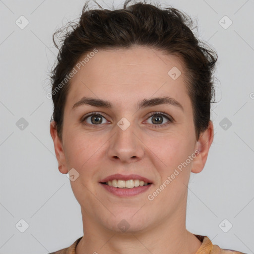 Joyful white young-adult female with short  brown hair and grey eyes