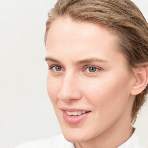 Joyful white young-adult female with short  brown hair and blue eyes