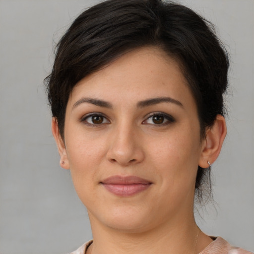 Joyful white young-adult female with short  brown hair and brown eyes