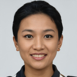 Joyful asian young-adult female with short  black hair and brown eyes