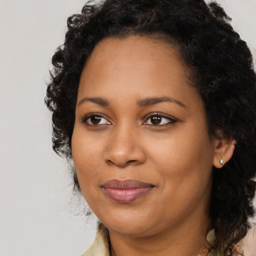 Joyful black young-adult female with medium  black hair and brown eyes