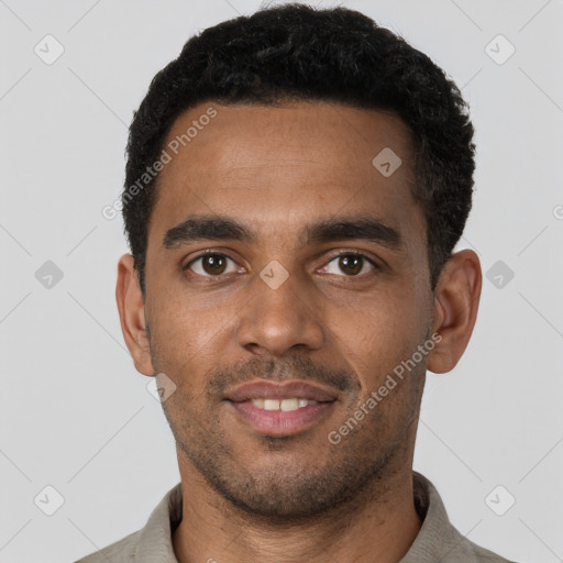 Joyful black young-adult male with short  black hair and brown eyes