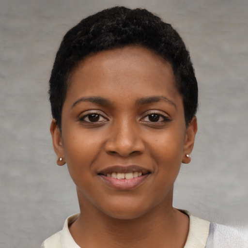 Joyful black young-adult female with short  black hair and brown eyes