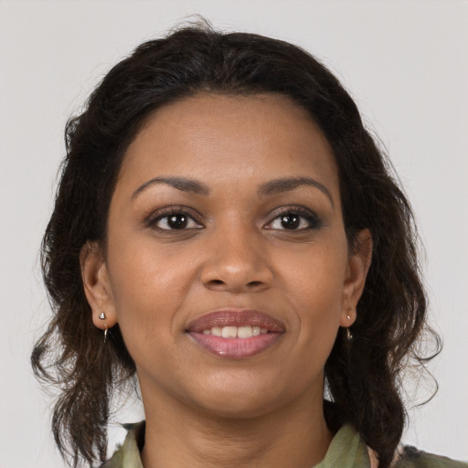 Joyful black young-adult female with medium  brown hair and brown eyes