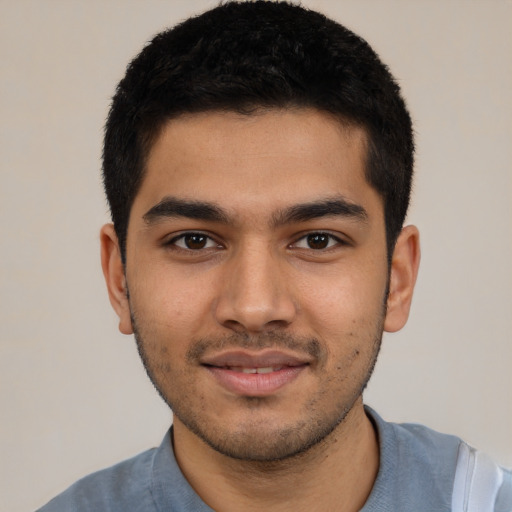 Joyful latino young-adult male with short  black hair and brown eyes