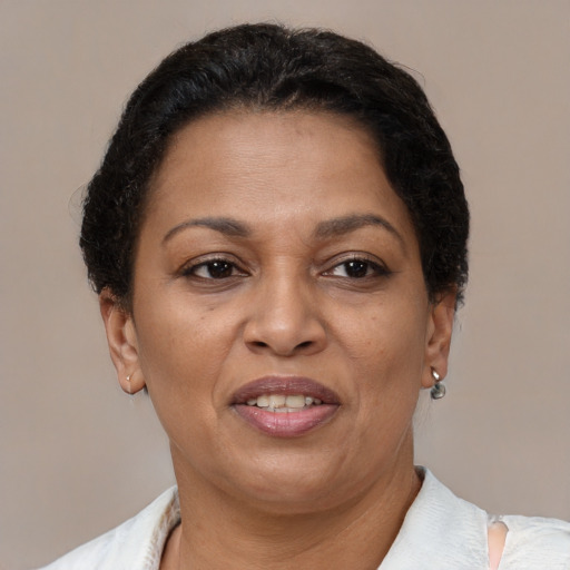 Joyful latino adult female with short  brown hair and brown eyes