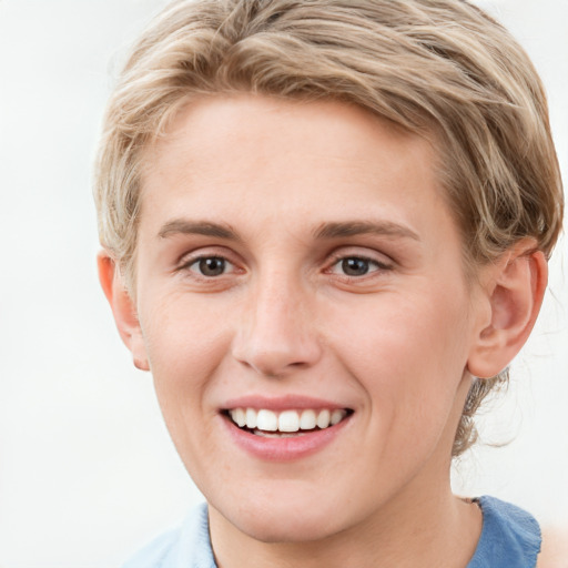 Joyful white young-adult female with short  brown hair and blue eyes