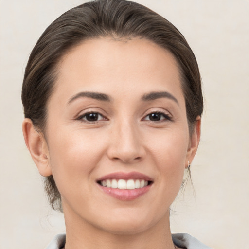 Joyful white young-adult female with medium  brown hair and brown eyes