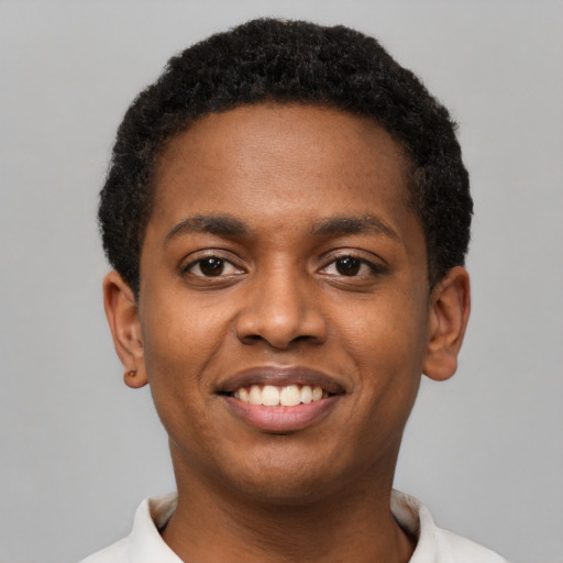Joyful black young-adult male with short  black hair and brown eyes