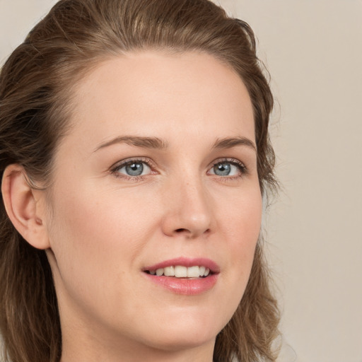 Joyful white young-adult female with long  brown hair and grey eyes