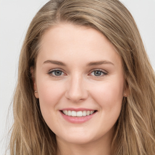 Joyful white young-adult female with long  brown hair and grey eyes