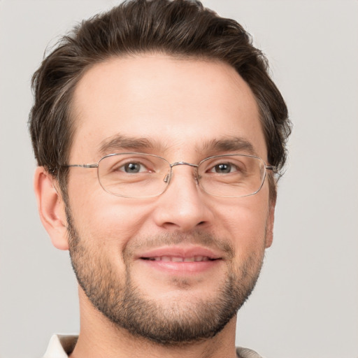 Joyful white adult male with short  brown hair and grey eyes