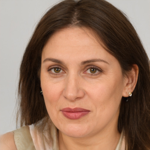 Joyful white adult female with long  brown hair and brown eyes