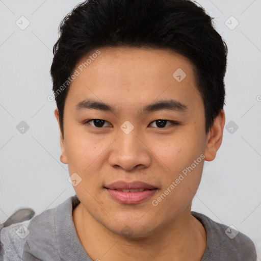 Joyful asian young-adult male with short  black hair and brown eyes