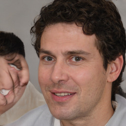 Joyful white adult male with short  brown hair and brown eyes