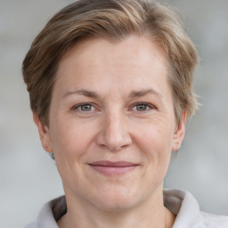 Joyful white adult female with short  brown hair and grey eyes