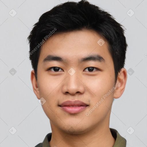 Joyful asian young-adult male with short  black hair and brown eyes