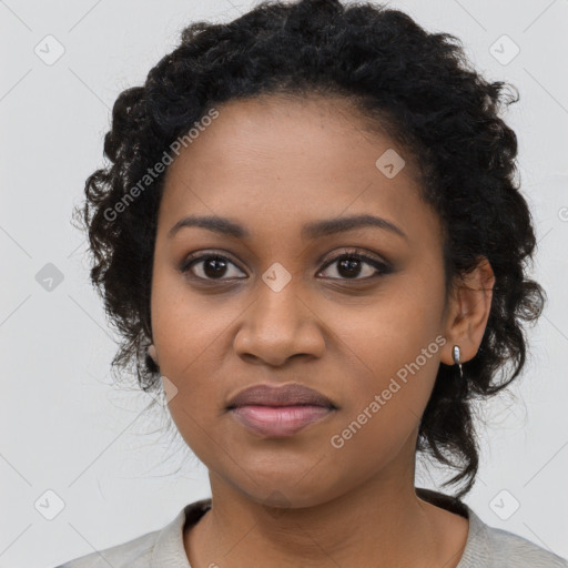 Joyful black young-adult female with long  black hair and brown eyes