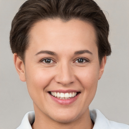 Joyful white young-adult female with short  brown hair and brown eyes