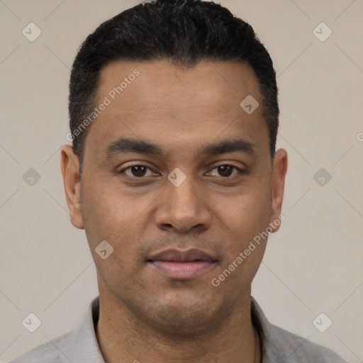 Joyful latino young-adult male with short  black hair and brown eyes