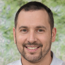 Joyful white adult male with short  brown hair and brown eyes