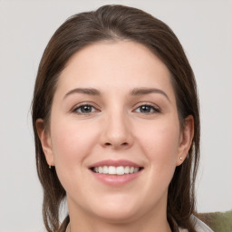 Joyful white young-adult female with medium  brown hair and grey eyes