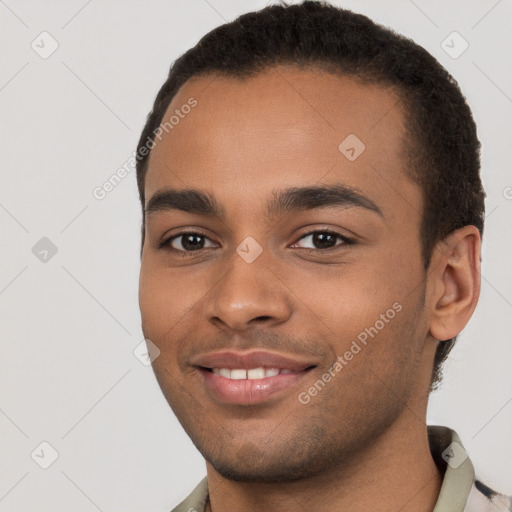 Joyful black young-adult male with short  brown hair and brown eyes