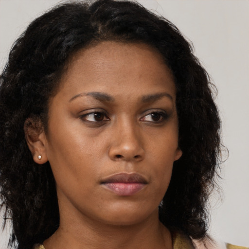 Neutral black young-adult female with medium  brown hair and brown eyes