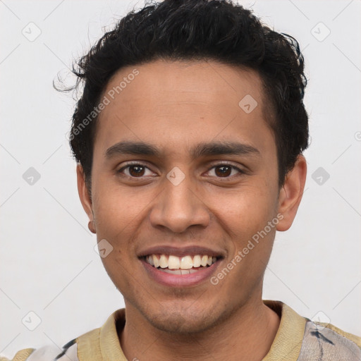 Joyful latino young-adult male with short  brown hair and brown eyes