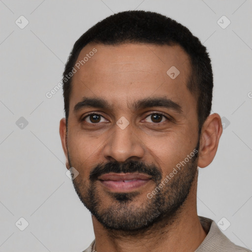 Joyful black young-adult male with short  black hair and brown eyes