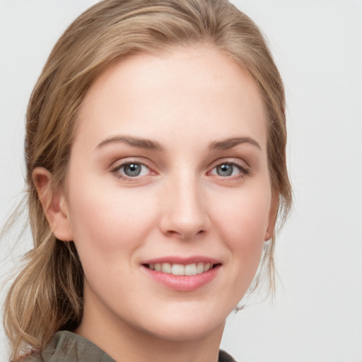 Joyful white young-adult female with medium  brown hair and blue eyes