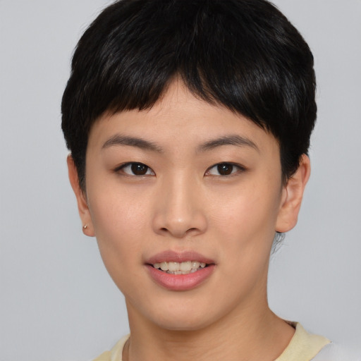 Joyful asian young-adult female with short  brown hair and brown eyes