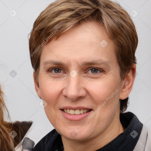 Joyful white adult female with medium  brown hair and blue eyes