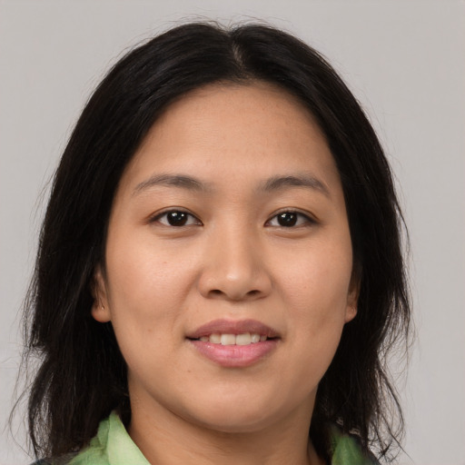 Joyful asian young-adult female with medium  brown hair and brown eyes
