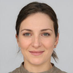 Joyful white young-adult female with medium  brown hair and grey eyes