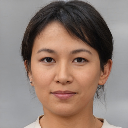 Joyful asian young-adult female with medium  brown hair and brown eyes