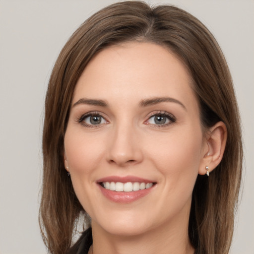 Joyful white young-adult female with long  brown hair and brown eyes