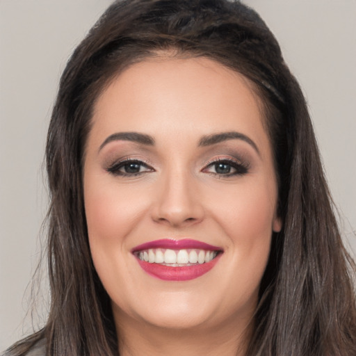 Joyful white young-adult female with long  brown hair and brown eyes