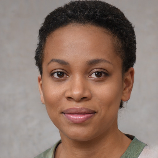 Joyful black young-adult female with short  brown hair and brown eyes