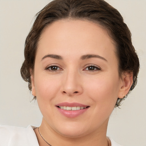 Joyful white young-adult female with medium  brown hair and brown eyes