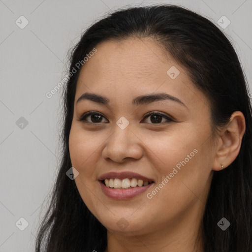 Joyful latino young-adult female with long  brown hair and brown eyes