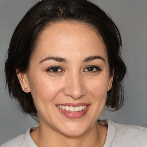 Joyful white young-adult female with medium  brown hair and brown eyes