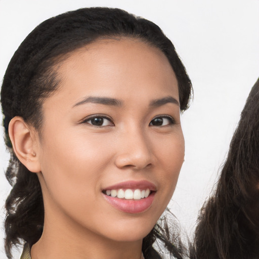 Joyful latino young-adult female with long  brown hair and brown eyes