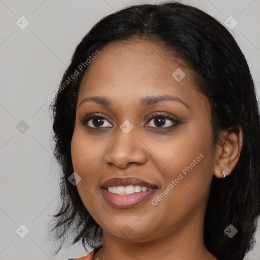 Joyful black young-adult female with long  black hair and brown eyes