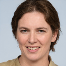 Joyful white adult female with medium  brown hair and grey eyes